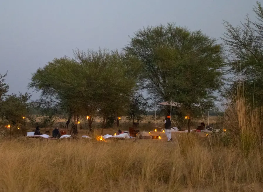 Residents gathered in the grasslands at dusk